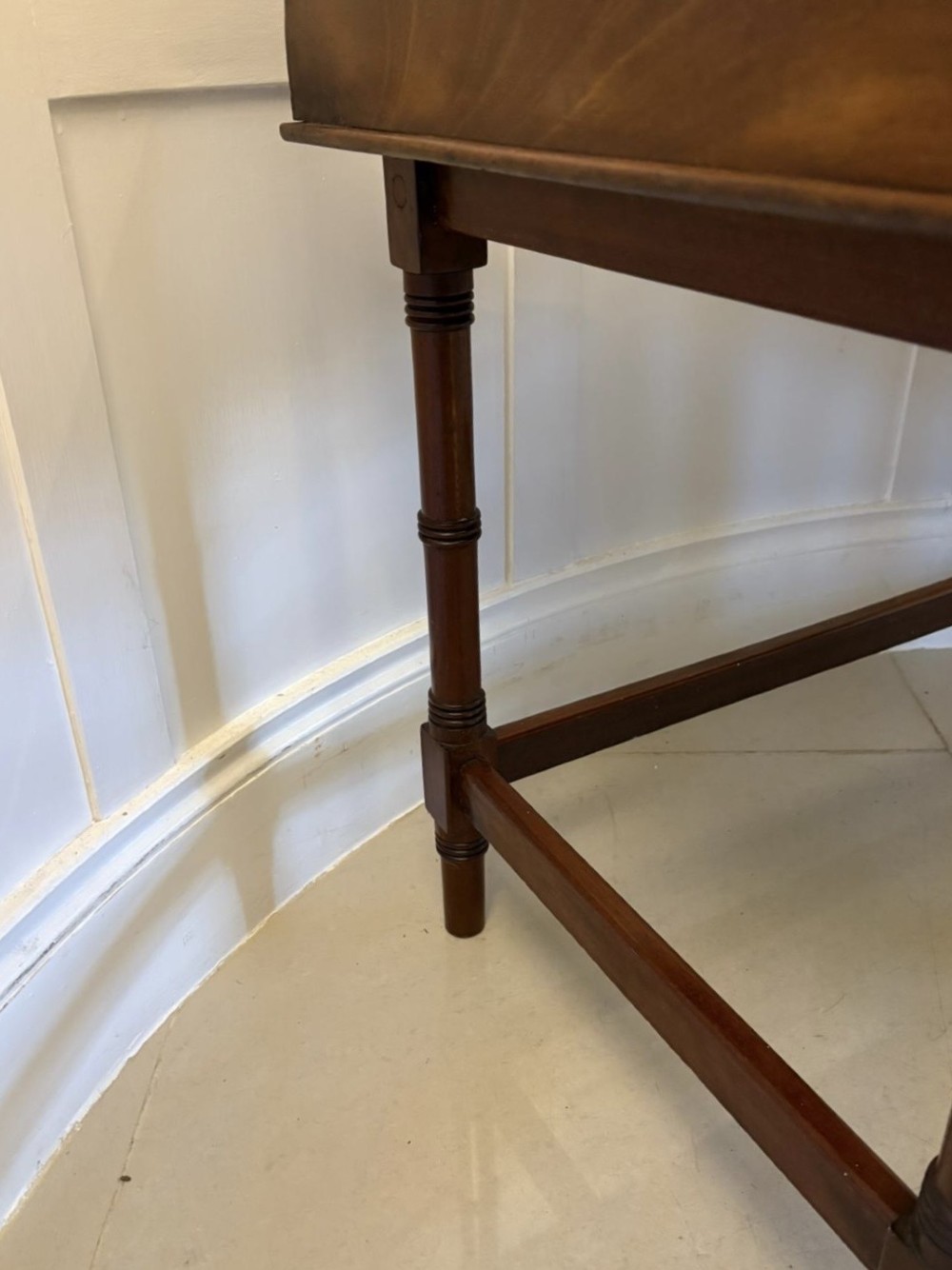 A dark mahogany tray-top occasional table featuring a raised gallery with carved carrying handles, turned legs, and stretchers. View II