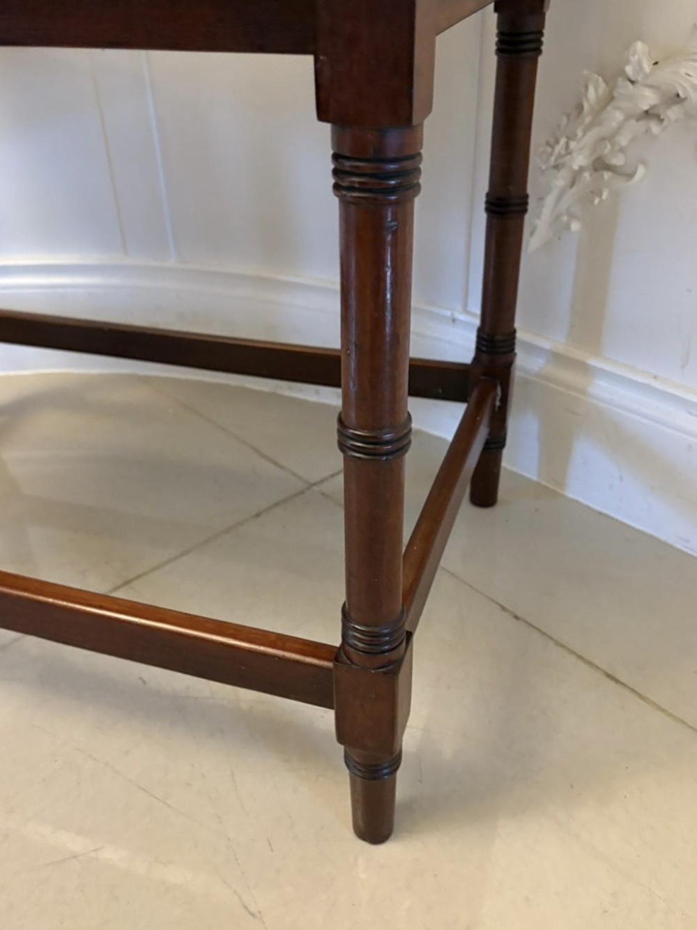 A dark mahogany tray-top occasional table featuring a raised gallery with carved carrying handles, turned legs, and stretchers. View III