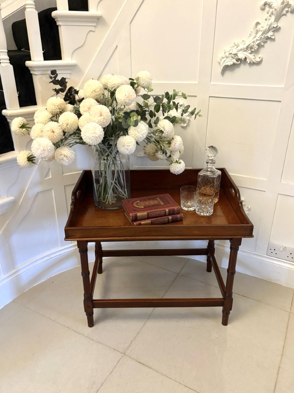 A dark mahogany tray-top occasional table featuring a raised gallery with carved carrying handles, turned legs, and stretchers. View IV