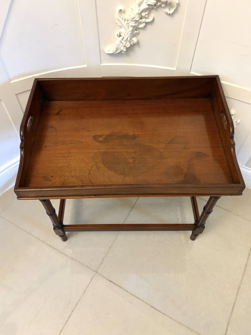 A dark mahogany tray-top occasional table featuring a raised gallery with carved carrying handles, turned legs, and stretchers. View VIII