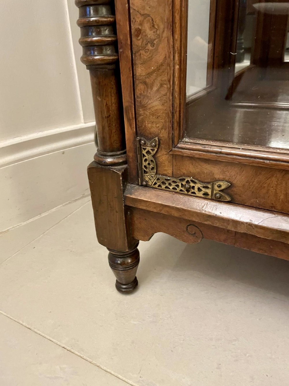 An antique Victorian burr walnut credenza featuring glazed flank doors, central geometric inlaid doors, brass fittings, and turned support columns. View II