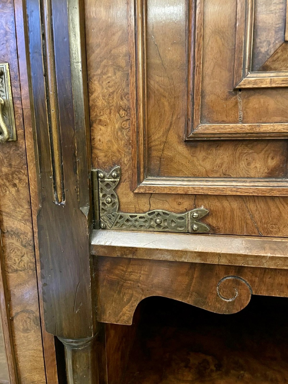 An antique Victorian burr walnut credenza featuring glazed flank doors, central geometric inlaid doors, brass fittings, and turned support columns. View VIII