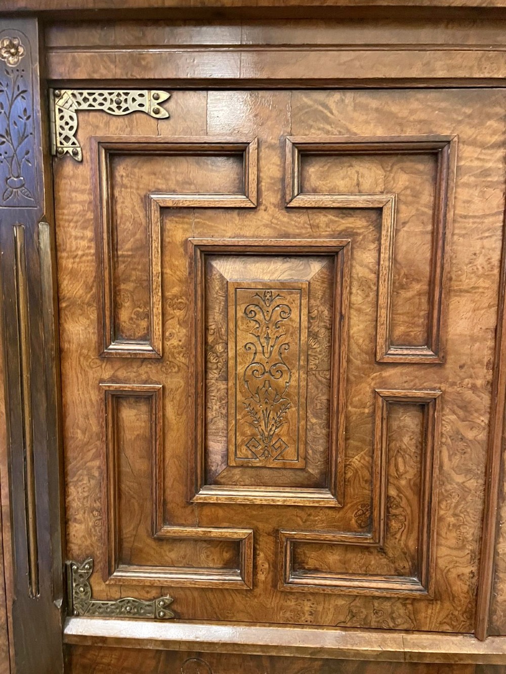An antique Victorian burr walnut credenza featuring glazed flank doors, central geometric inlaid doors, brass fittings, and turned support columns. View X