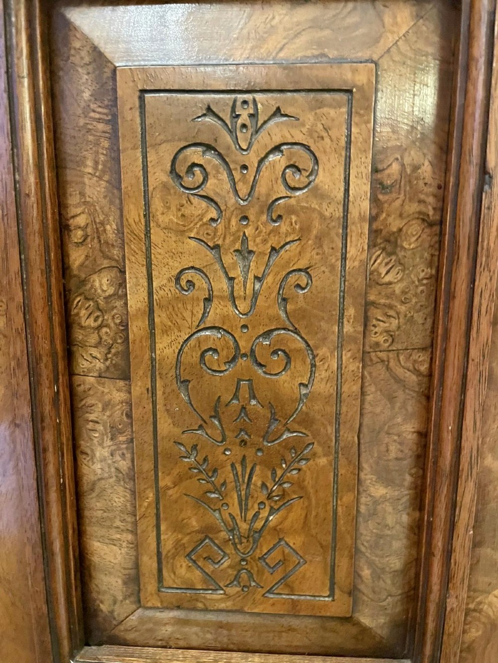 An antique Victorian burr walnut credenza featuring glazed flank doors, central geometric inlaid doors, brass fittings, and turned support columns. View XII