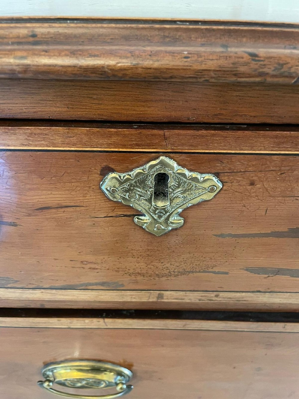 A George III mahogany chest on stand featuring two short over two long drawers, brass handles, a carved shell apron, and cabriole legs. View XII