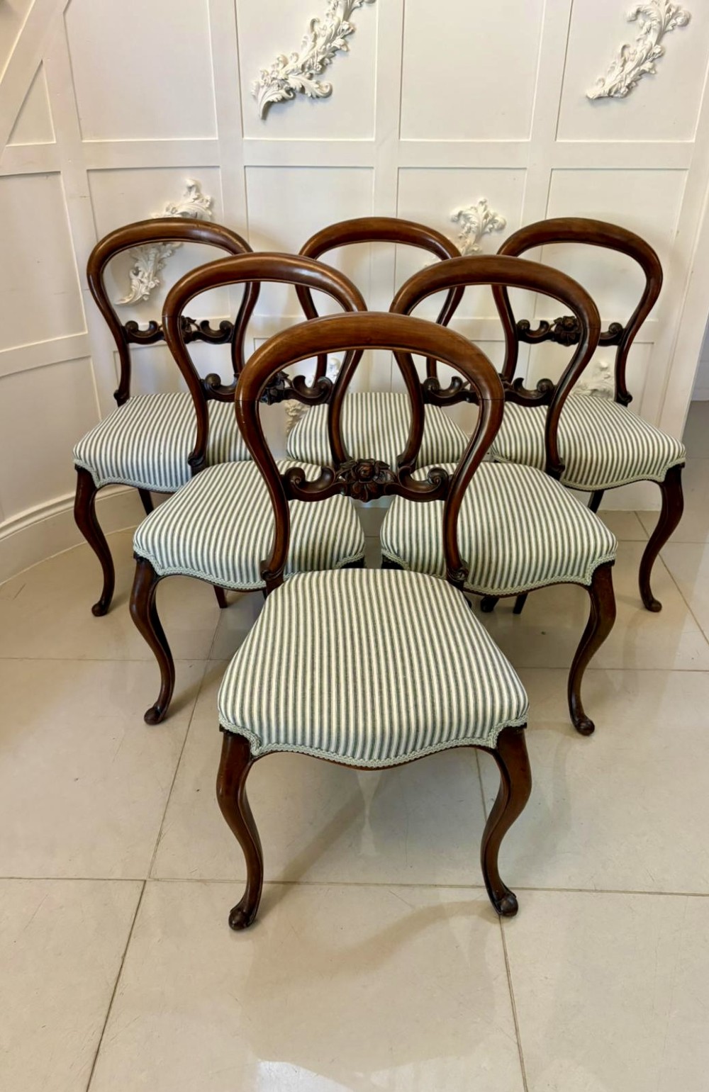 Set of six antique Victorian mahogany dining chairs featuring carved balloon backrests, cabriole front legs, and green-and-white striped fabric seats. View II