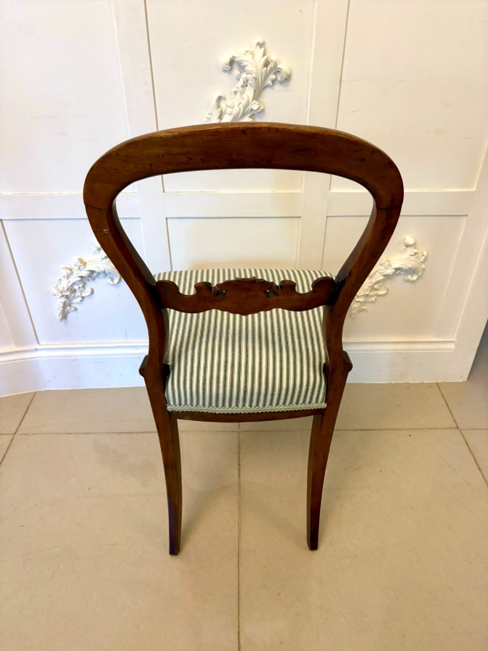 Set of six antique Victorian mahogany dining chairs featuring carved balloon backrests, cabriole front legs, and green-and-white striped fabric seats. View VI