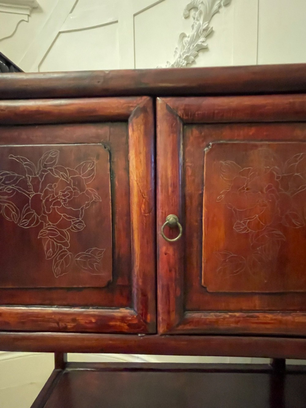 An antique dark reddish-brown Chinese hardwood display cabinet featuring asymmetrical open shelves, carved scrollwork galleries, and two small cupboards. View VI