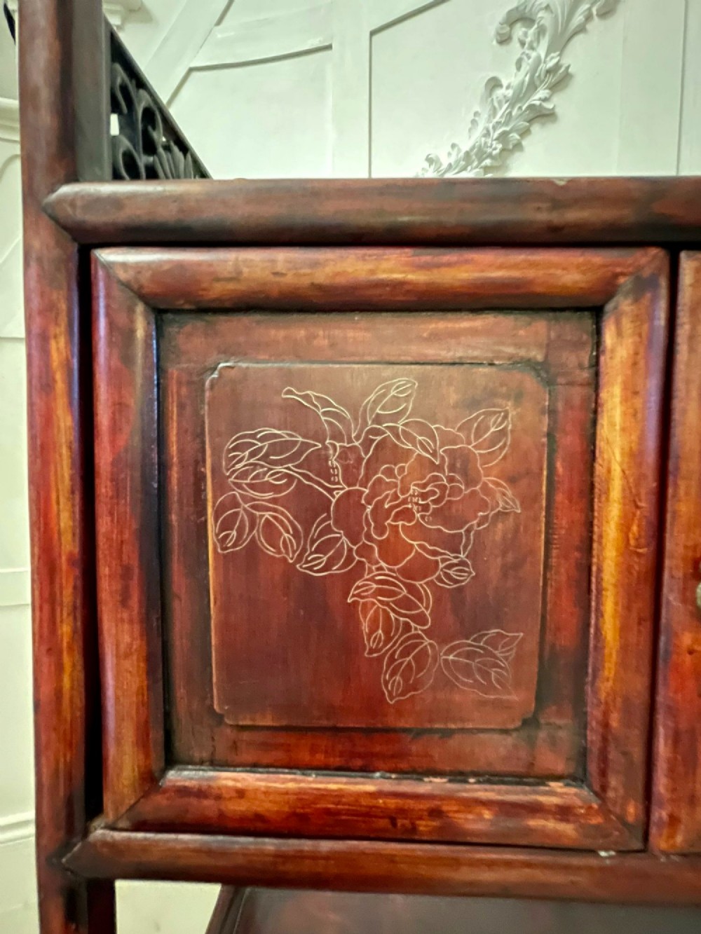 An antique dark reddish-brown Chinese hardwood display cabinet featuring asymmetrical open shelves, carved scrollwork galleries, and two small cupboards. View VII