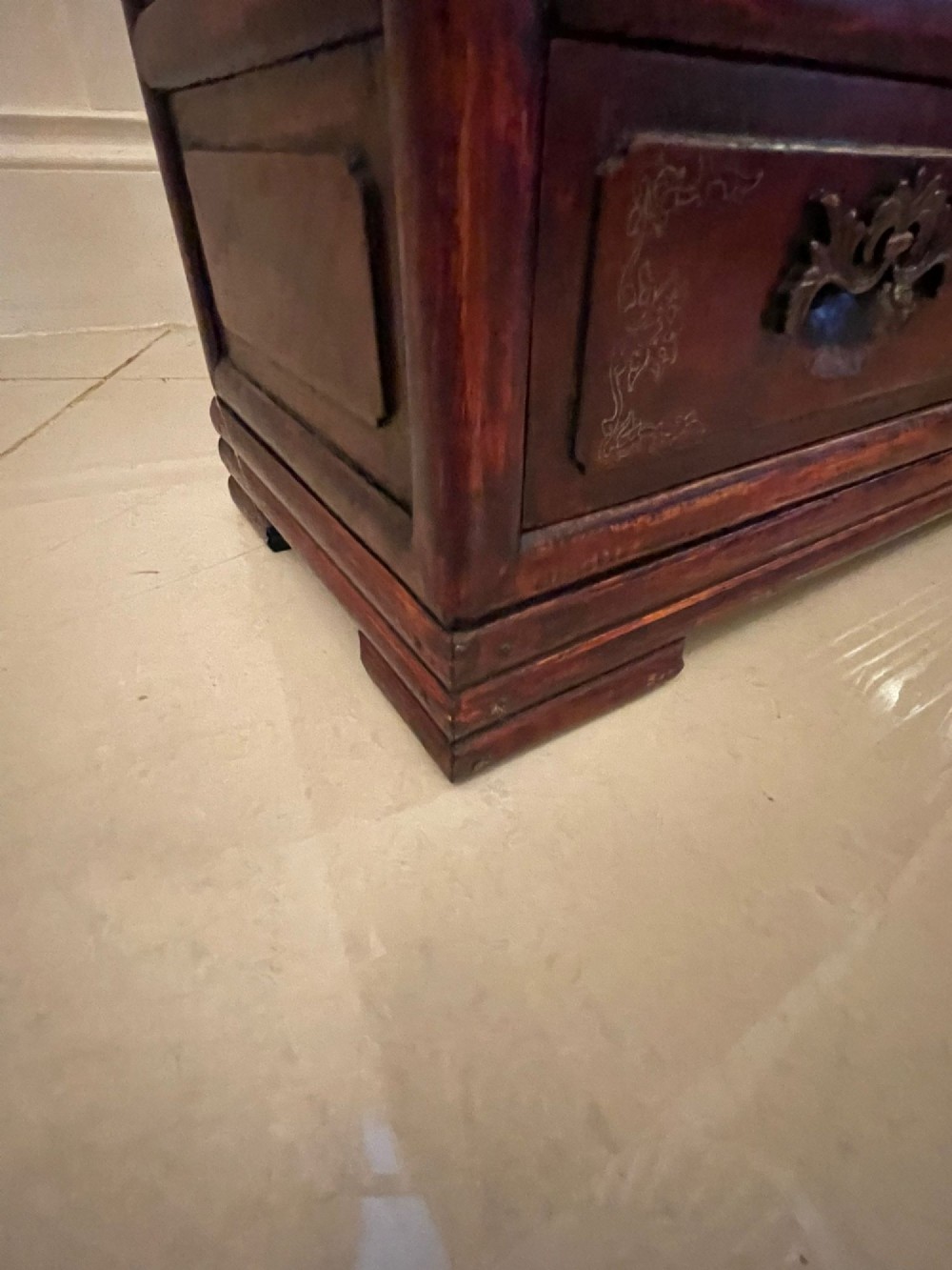 An antique dark reddish-brown Chinese hardwood display cabinet featuring asymmetrical open shelves, carved scrollwork galleries, and two small cupboards. View XII