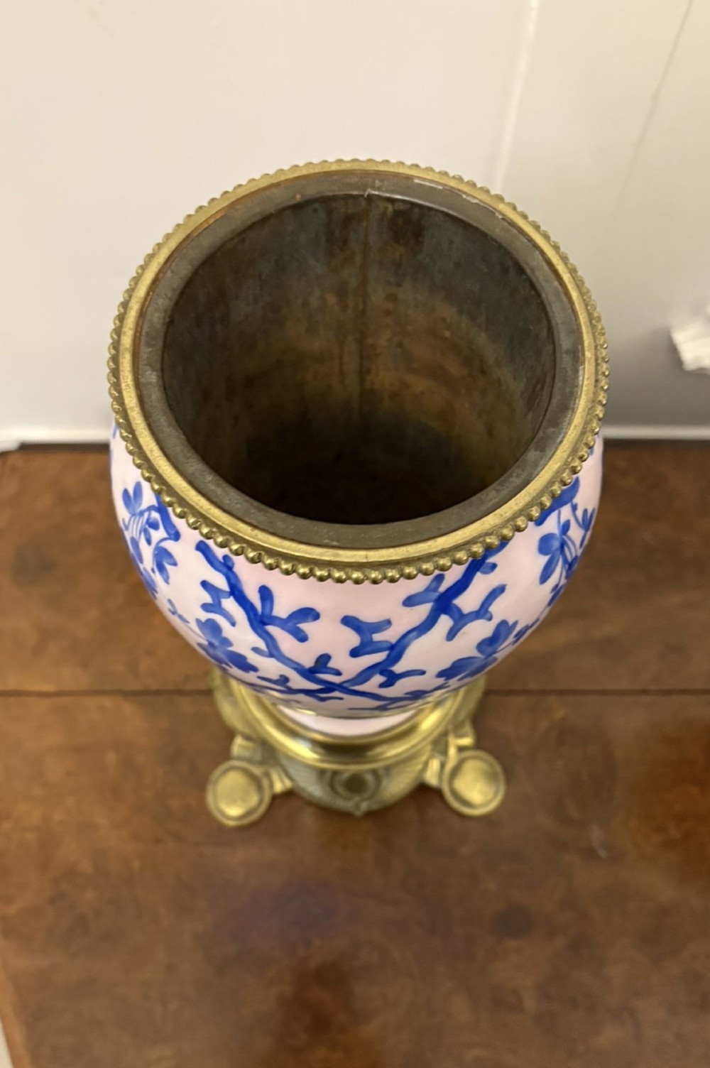 A tall Victorian oil lamp featuring a pink porcelain body with blue floral trellis decoration, a cast brass base, a cut glass reservoir, and an etched glass shade. View III