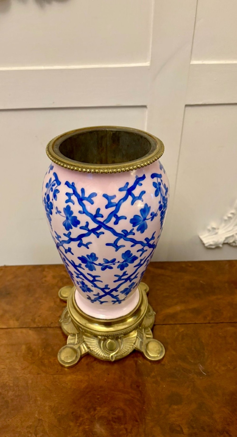 A tall Victorian oil lamp featuring a pink porcelain body with blue floral trellis decoration, a cast brass base, a cut glass reservoir, and an etched glass shade. View IV