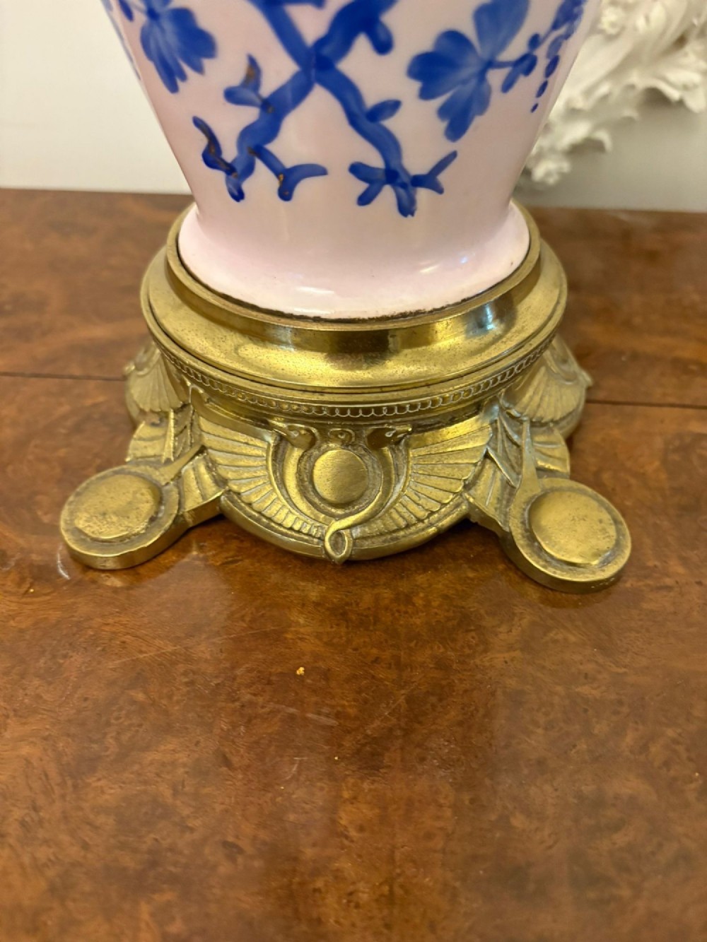 A tall Victorian oil lamp featuring a pink porcelain body with blue floral trellis decoration, a cast brass base, a cut glass reservoir, and an etched glass shade. View V