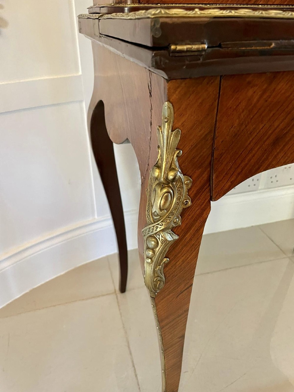 A French kingwood writing desk featuring a stepped upper superstructure with drawers, gilt-bronze mounts, parquetry veneer, and cabriole legs. View IX