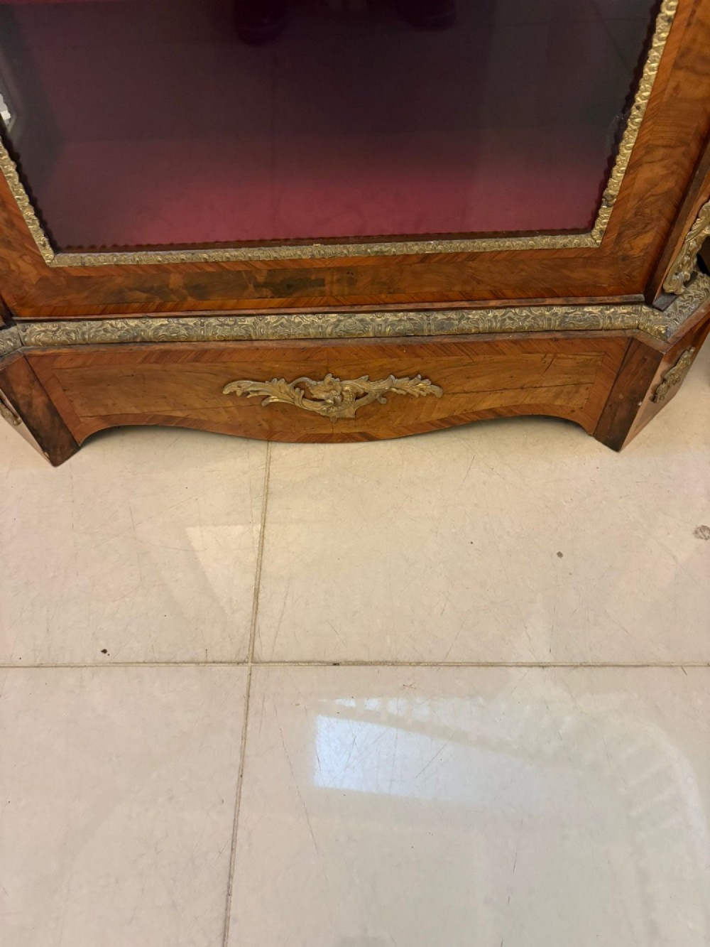 A pair of Victorian burr walnut pier cabinets featuring glazed front doors, velvet-lined interior shelves, and ornate gilt metal mounts. View III