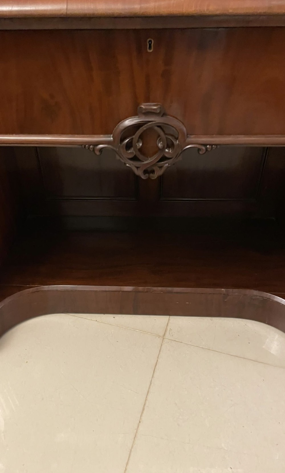 A Victorian carved mahogany sideboard featuring a curved front, open central bay, flanked cupboards, and a large arched mirror backrest adorned with scroll carving. View X