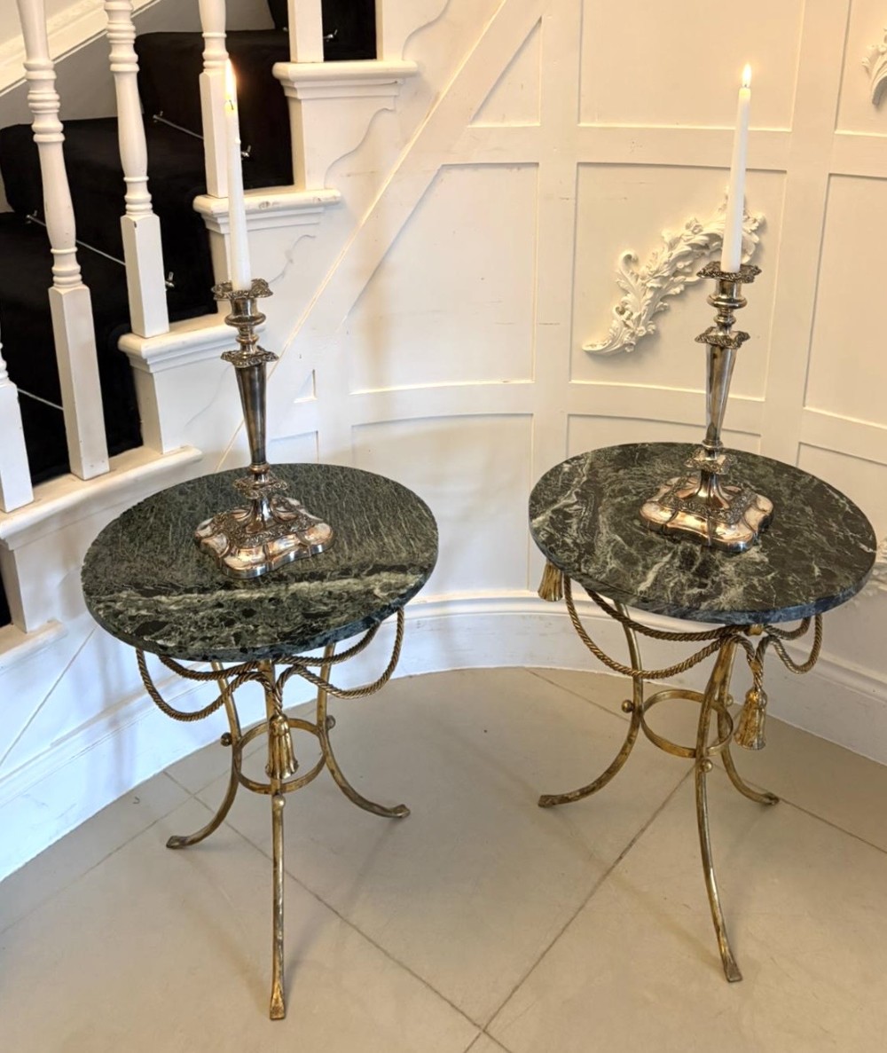 A pair of circular Italian side tables featuring dark green marble tops supported by gilt metal legs adorned with draped rope and tassel motifs. View V