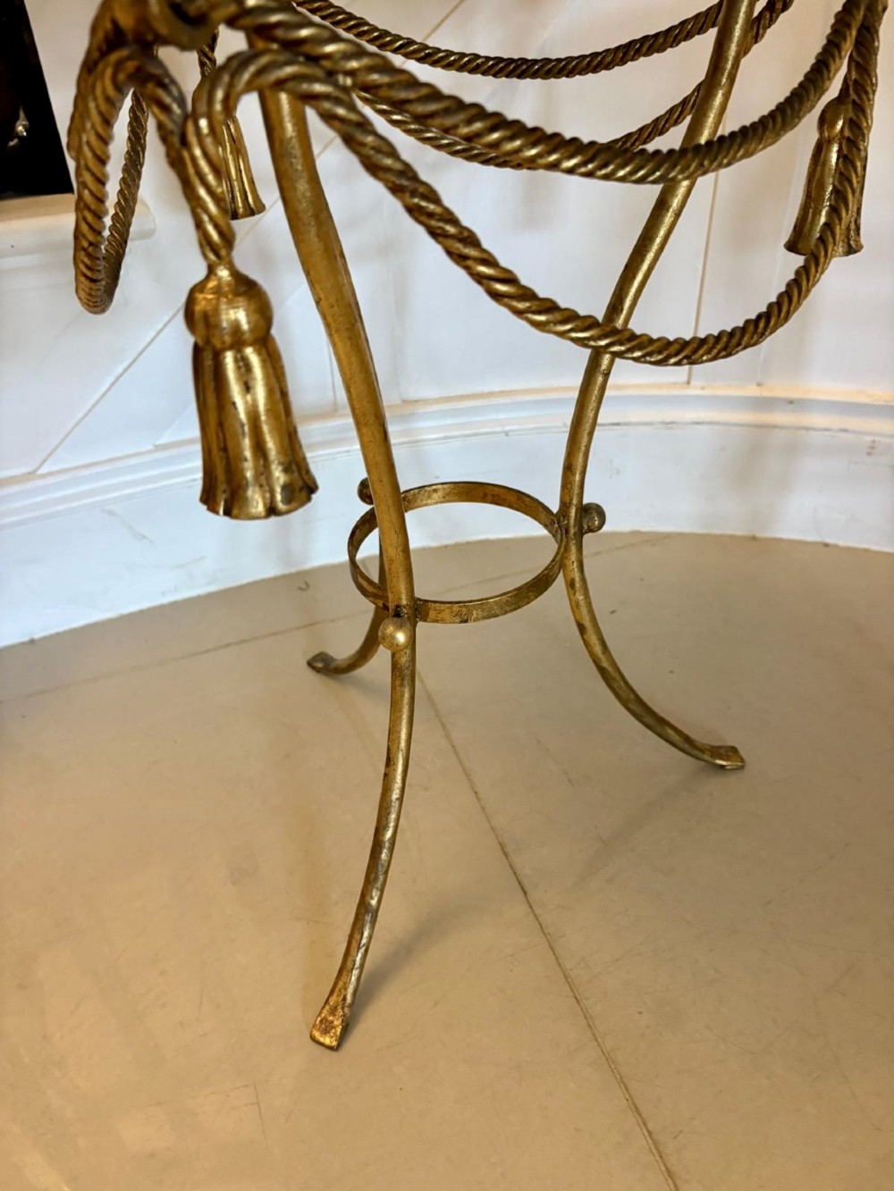 A pair of circular Italian side tables featuring dark green marble tops supported by gilt metal legs adorned with draped rope and tassel motifs. View IX