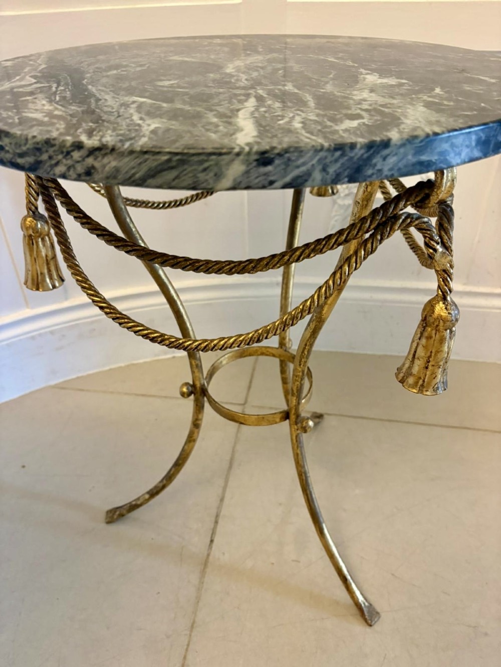A pair of circular Italian side tables featuring dark green marble tops supported by gilt metal legs adorned with draped rope and tassel motifs. View XI