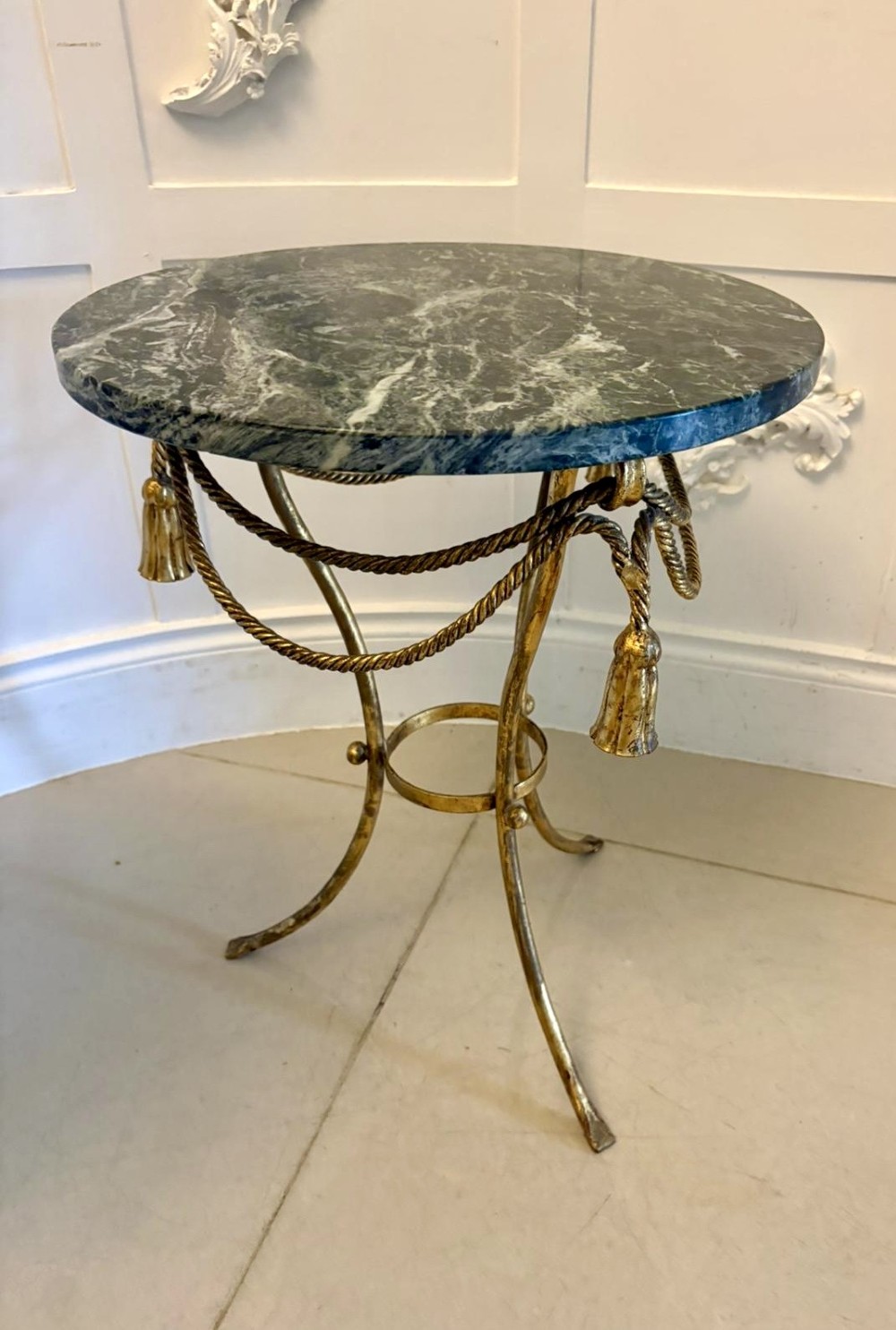 A pair of circular Italian side tables featuring dark green marble tops supported by gilt metal legs adorned with draped rope and tassel motifs. View XII