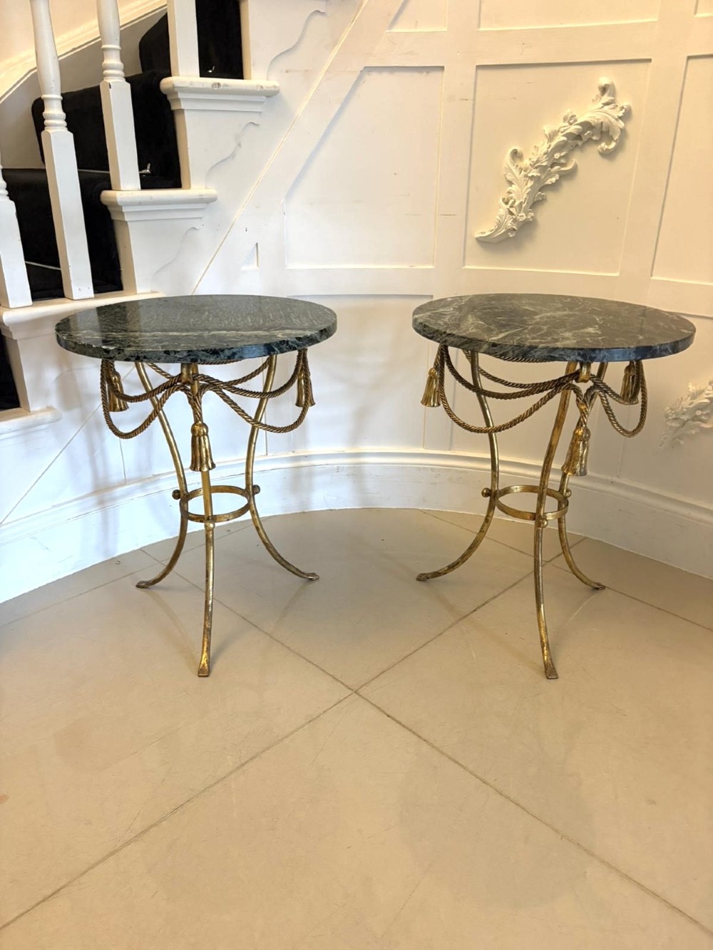 A pair of circular Italian side tables featuring dark green marble tops supported by gilt metal legs adorned with draped rope and tassel motifs. View XIII