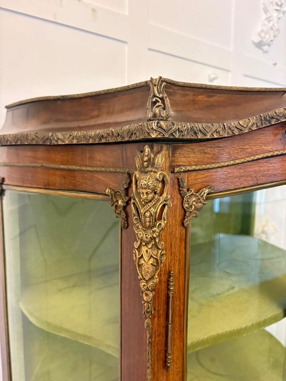 A French Louis XV Revival Vernis Martin vitrine cabinet featuring bowed glass doors, gilt bronze mounts, painted lower panels depicting figures, and a fabric-lined interior. View III