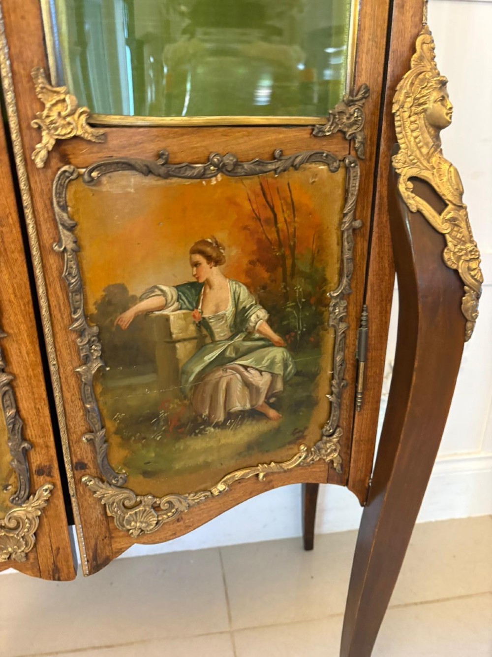 A French Louis XV Revival Vernis Martin vitrine cabinet featuring bowed glass doors, gilt bronze mounts, painted lower panels depicting figures, and a fabric-lined interior. View VIII