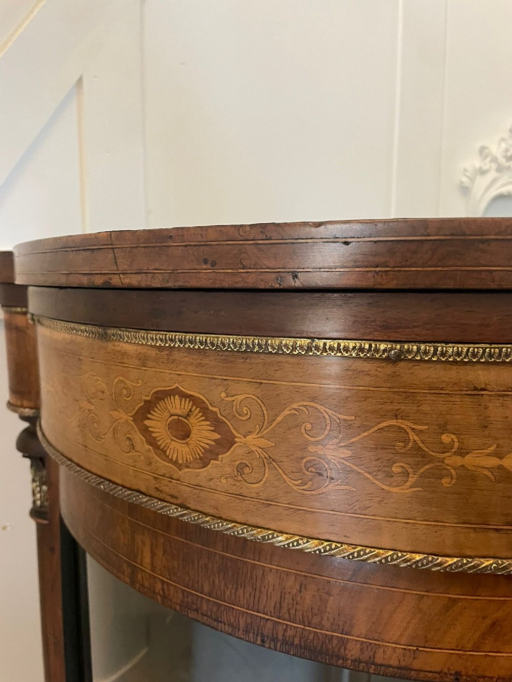 A Victorian burr walnut credenza with a central marquetry inlaid door, gilt ormolu mounts, and two curved glass side display cabinets. View IV