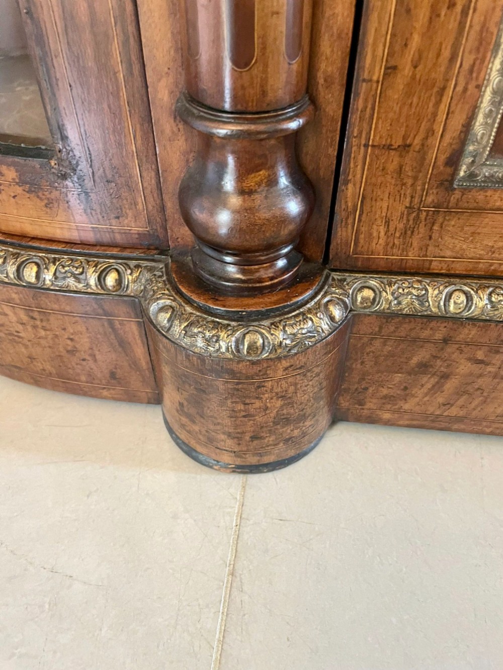 A Victorian burr walnut credenza with a central marquetry inlaid door, gilt ormolu mounts, and two curved glass side display cabinets. View XIII