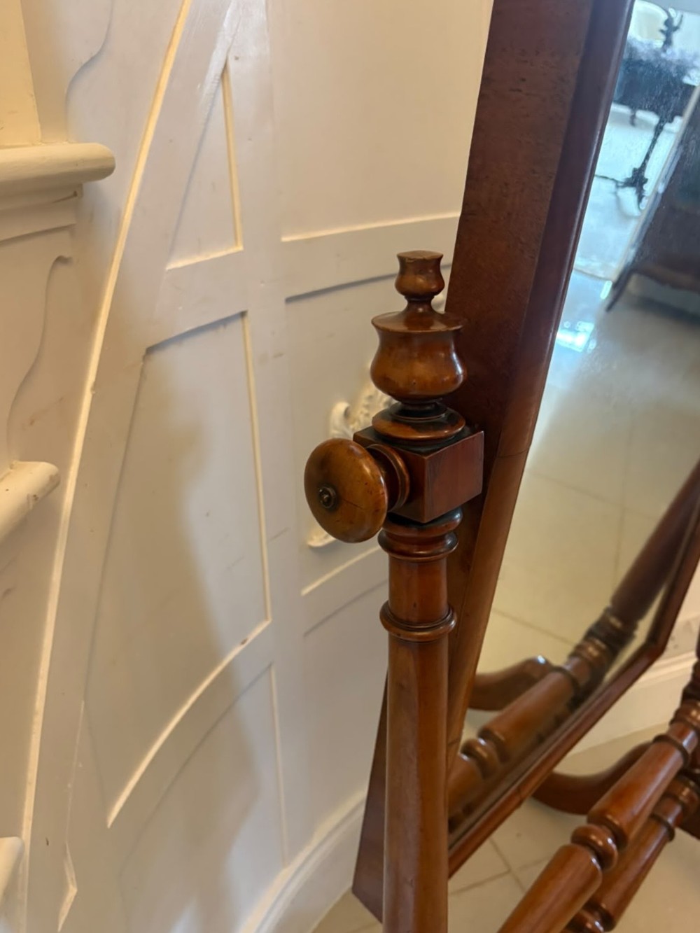 A Victorian mahogany freestanding cheval mirror featuring turned upright pillars, arched legs, and a swivelling full-length mirror frame. View V