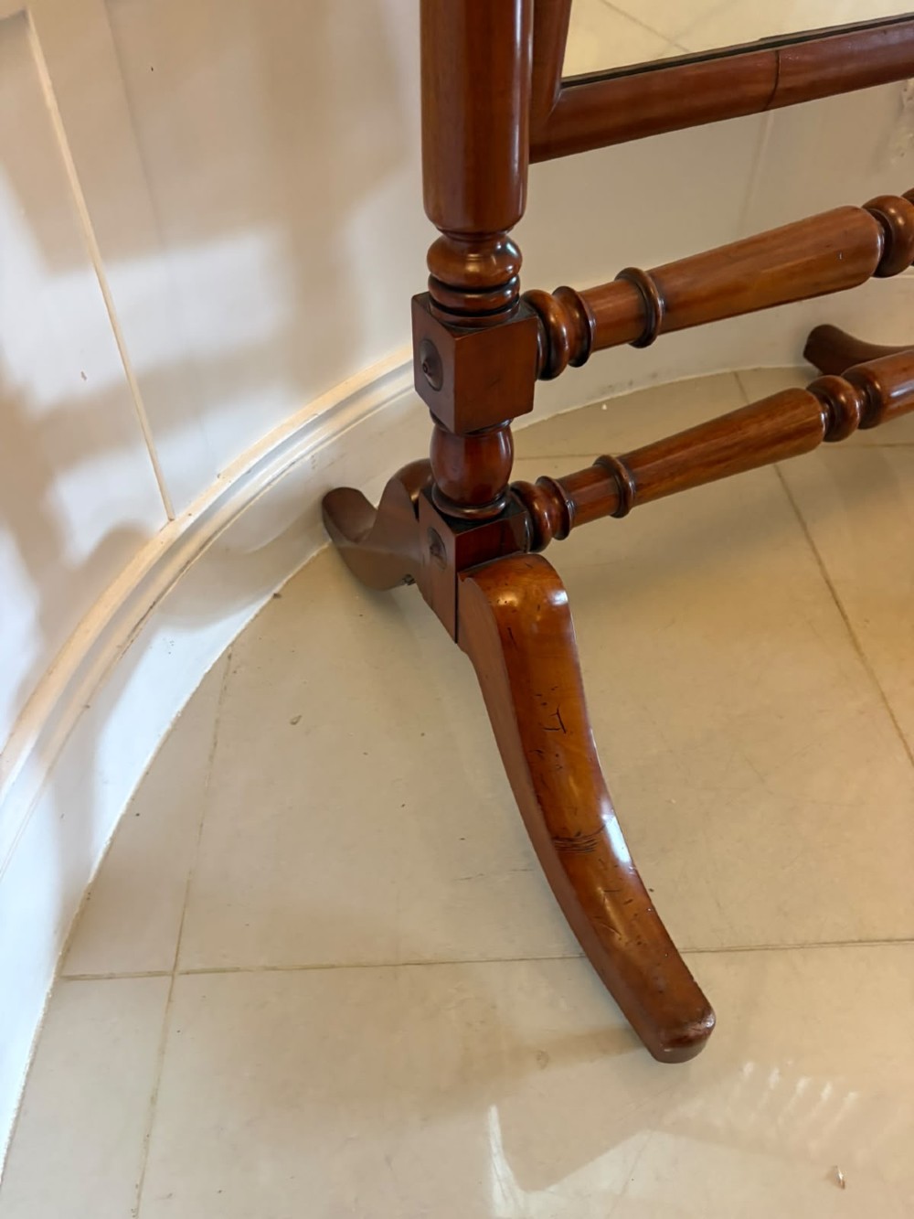 A Victorian mahogany freestanding cheval mirror featuring turned upright pillars, arched legs, and a swivelling full-length mirror frame. View VI