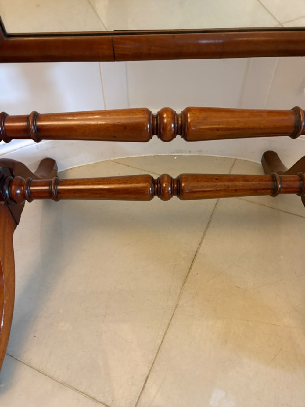 A Victorian mahogany freestanding cheval mirror featuring turned upright pillars, arched legs, and a swivelling full-length mirror frame. View VII