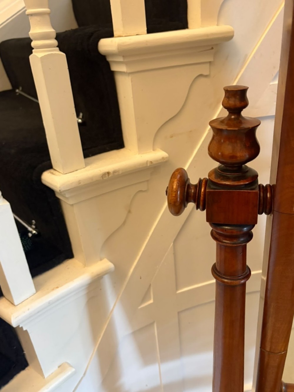 A Victorian mahogany freestanding cheval mirror featuring turned upright pillars, arched legs, and a swivelling full-length mirror frame. View X