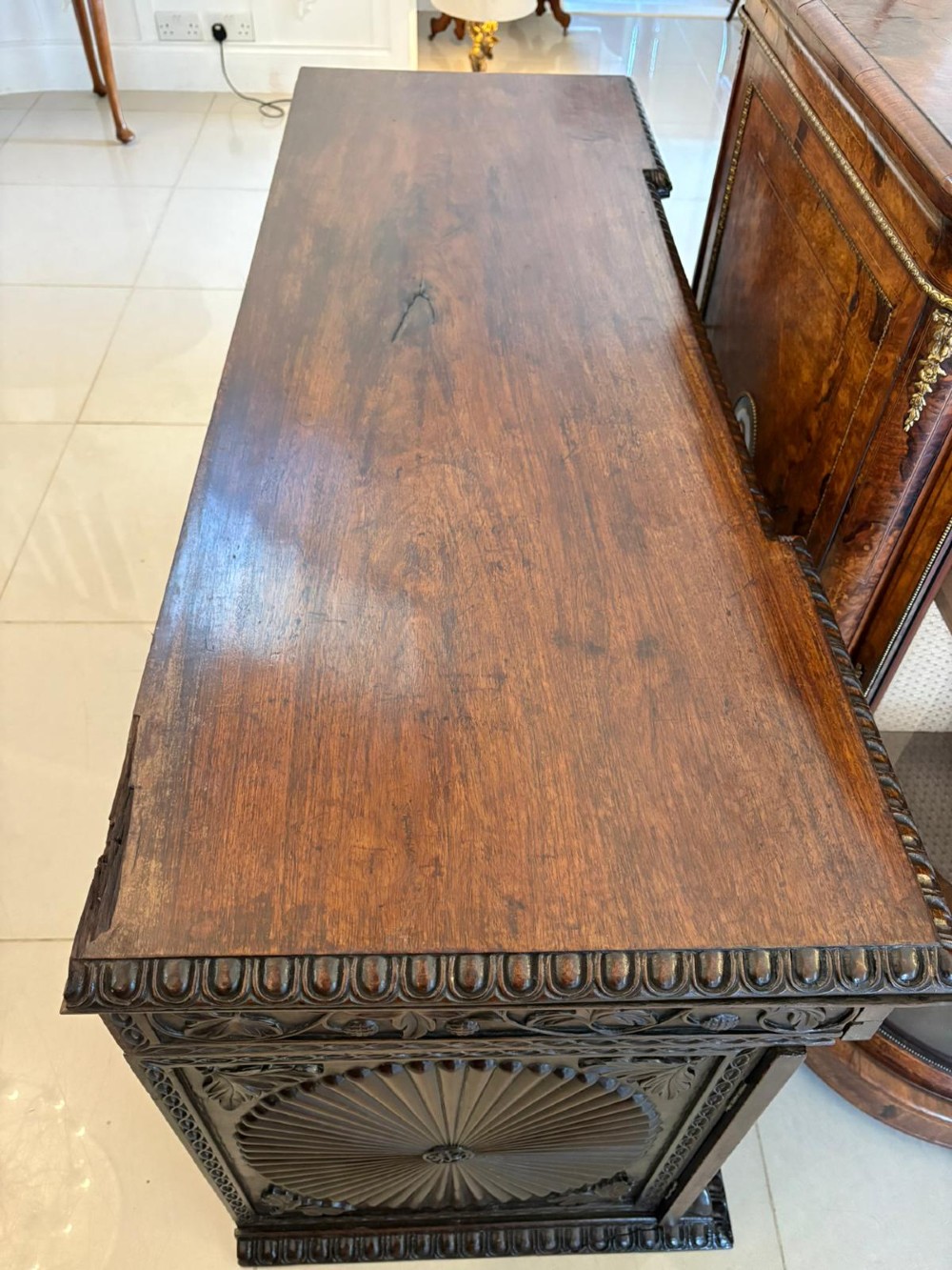 A Victorian burr walnut credenza featuring a central oval mirrored door flanked by curved bow-front glass doors and gilt ormolu mounts. View II