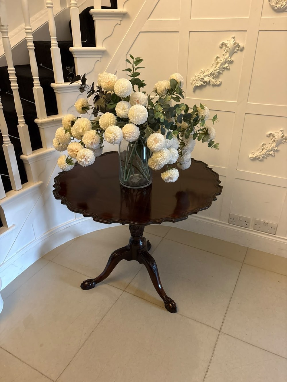 A mahogany George III style tilt-top centre table featuring a scalloped piecrust edge, central pedestal, and tripod cabriole legs with claw and ball feet. View III