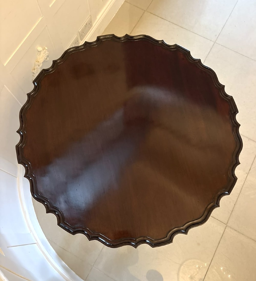 A mahogany George III style tilt-top centre table featuring a scalloped piecrust edge, central pedestal, and tripod cabriole legs with claw and ball feet. View V