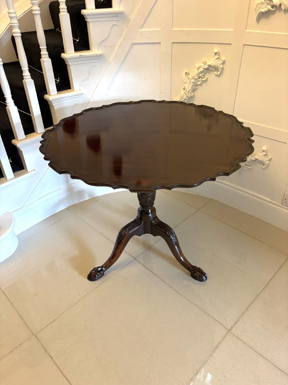 A mahogany George III style tilt-top centre table featuring a scalloped piecrust edge, central pedestal, and tripod cabriole legs with claw and ball feet. View IX