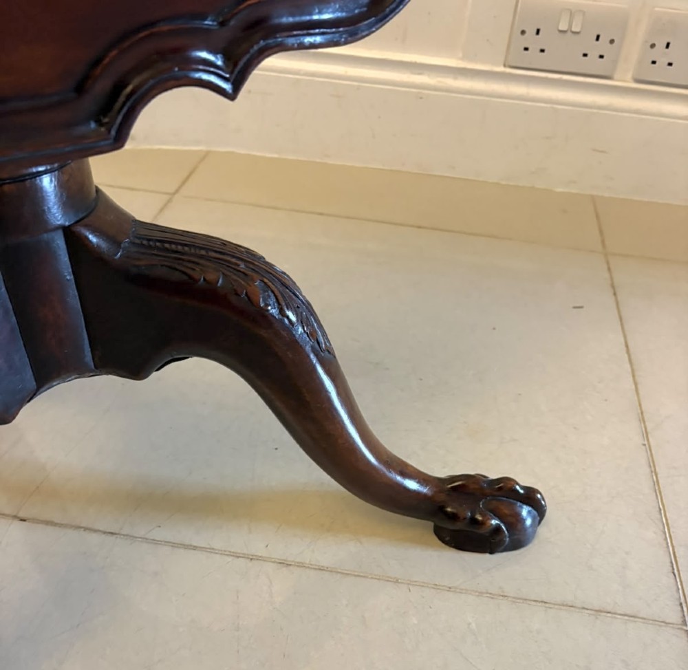 A mahogany George III style tilt-top centre table featuring a scalloped piecrust edge, central pedestal, and tripod cabriole legs with claw and ball feet. View XII
