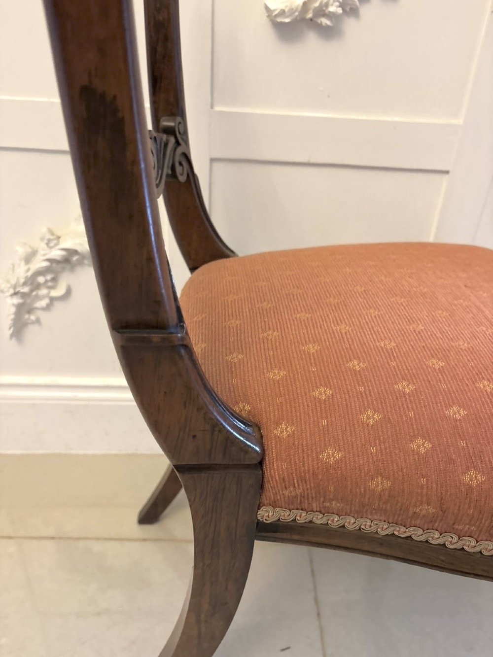 A set of four antique Regency rosewood dining chairs featuring carved scroll top rails and pattern-upholstered seats on turned front legs. View IV