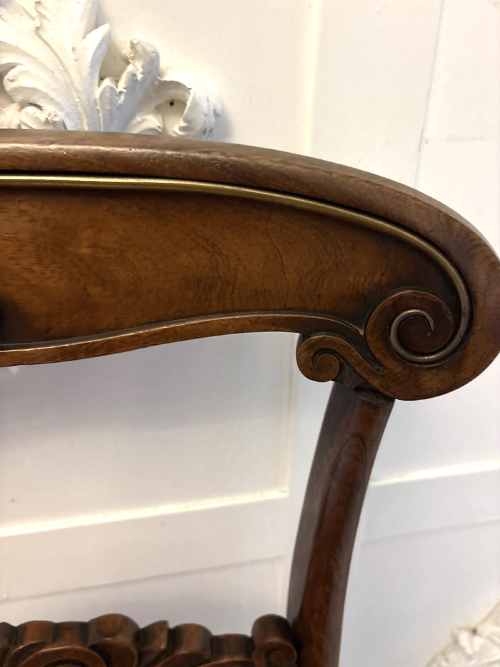 A set of four antique Regency rosewood dining chairs featuring carved scroll top rails and pattern-upholstered seats on turned front legs. View IX