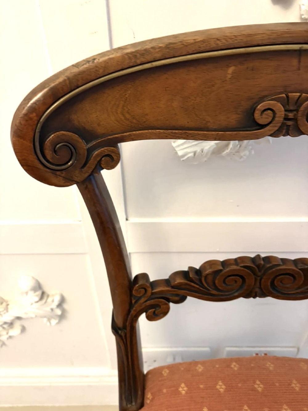 A set of four antique Regency rosewood dining chairs featuring carved scroll top rails and pattern-upholstered seats on turned front legs. View XI
