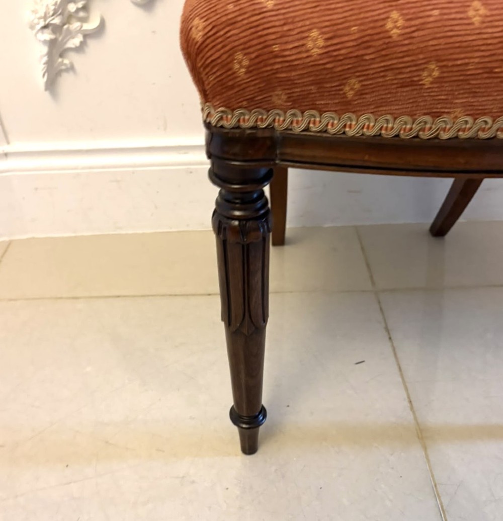 A set of four antique Regency rosewood dining chairs featuring carved scroll top rails and pattern-upholstered seats on turned front legs. View XII