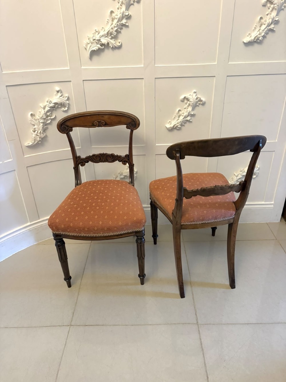 A set of four antique Regency rosewood dining chairs featuring carved scroll top rails and pattern-upholstered seats on turned front legs. View XIII