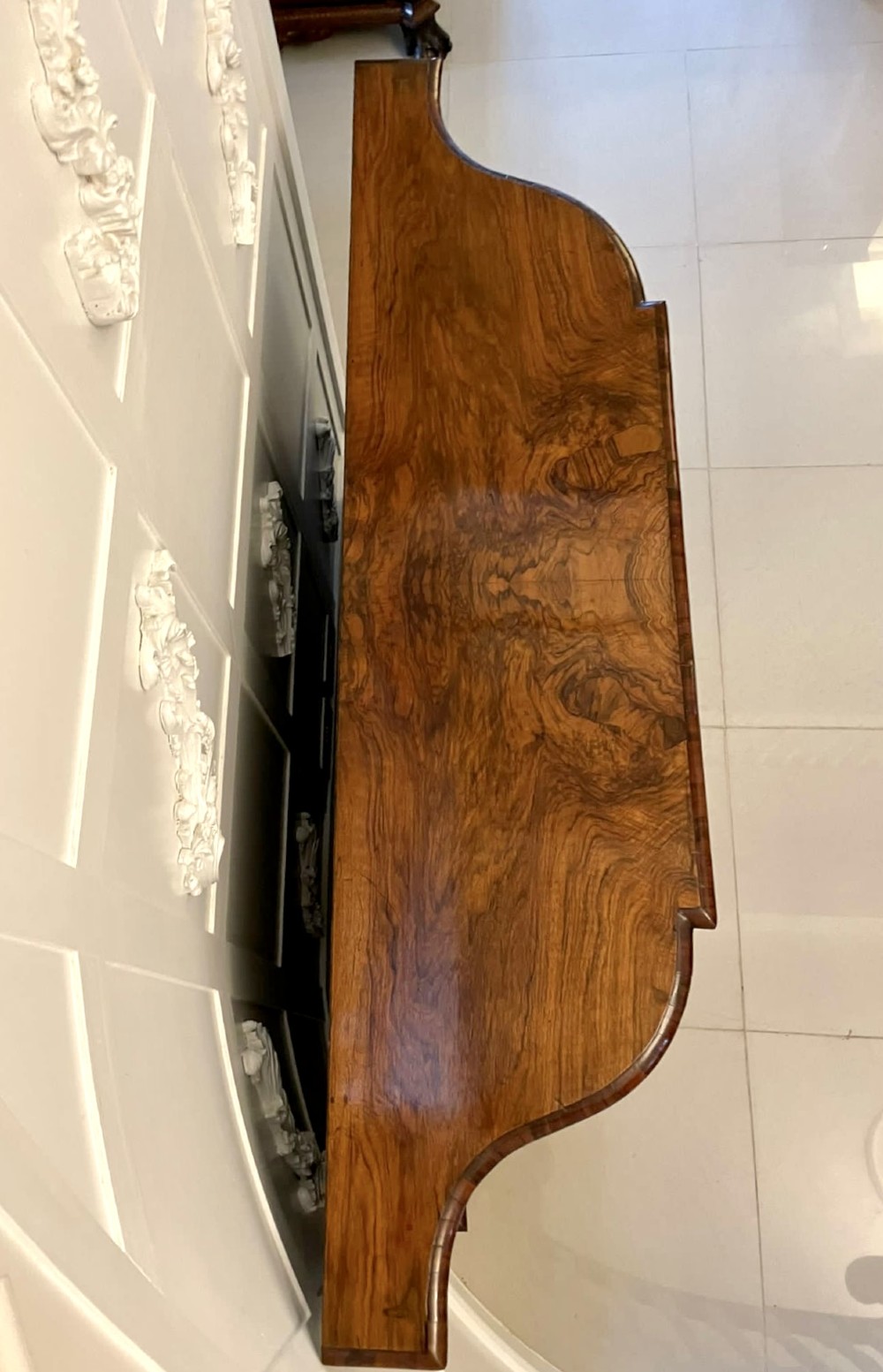 A Victorian burr walnut credenza featuring a central glass door, open serpentine display shelves, and detailed brass ormolu mounts. View VII