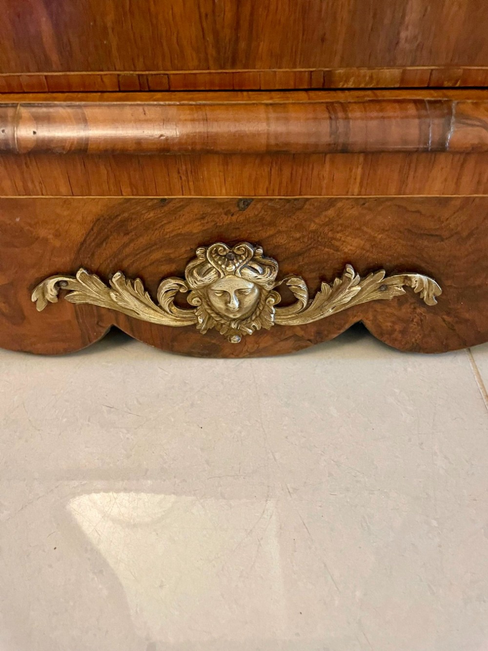 A Victorian burr walnut credenza featuring a central glass door, open serpentine display shelves, and detailed brass ormolu mounts. View IX