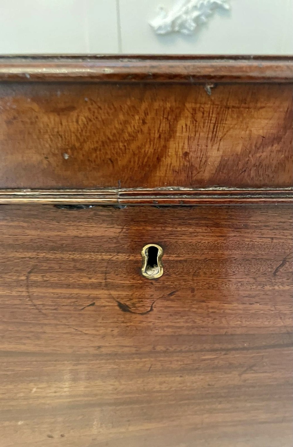 A Georgian mahogany cellarette featuring a tapered rectangular body on turned legs with brass lion-mask side handles and a keyhole lid. View XIII