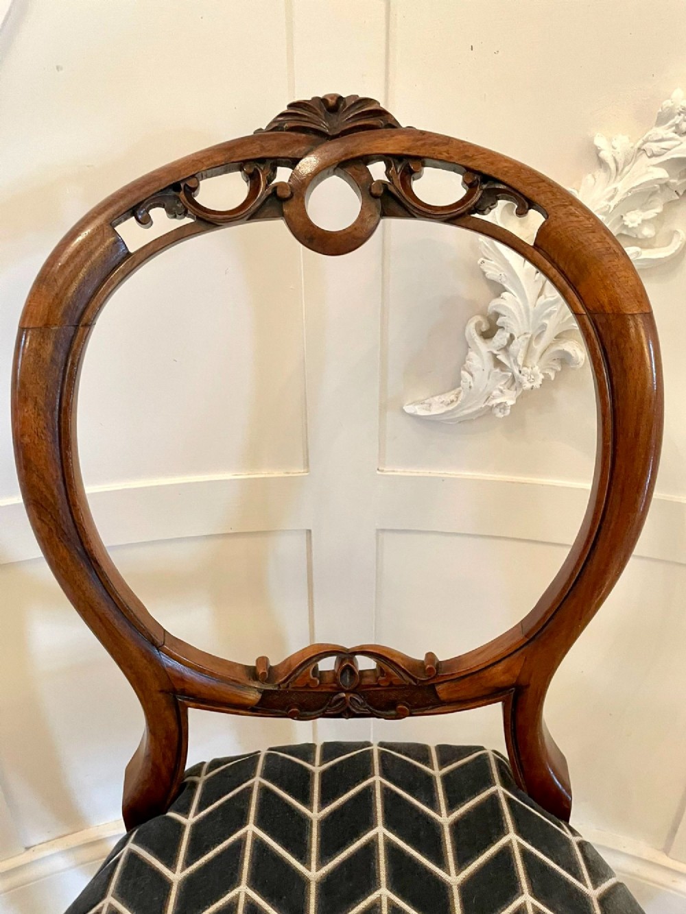 A set of six Victorian carved walnut balloon back dining chairs featuring cabriole legs and grey geometric velvet upholstered seats. View IV