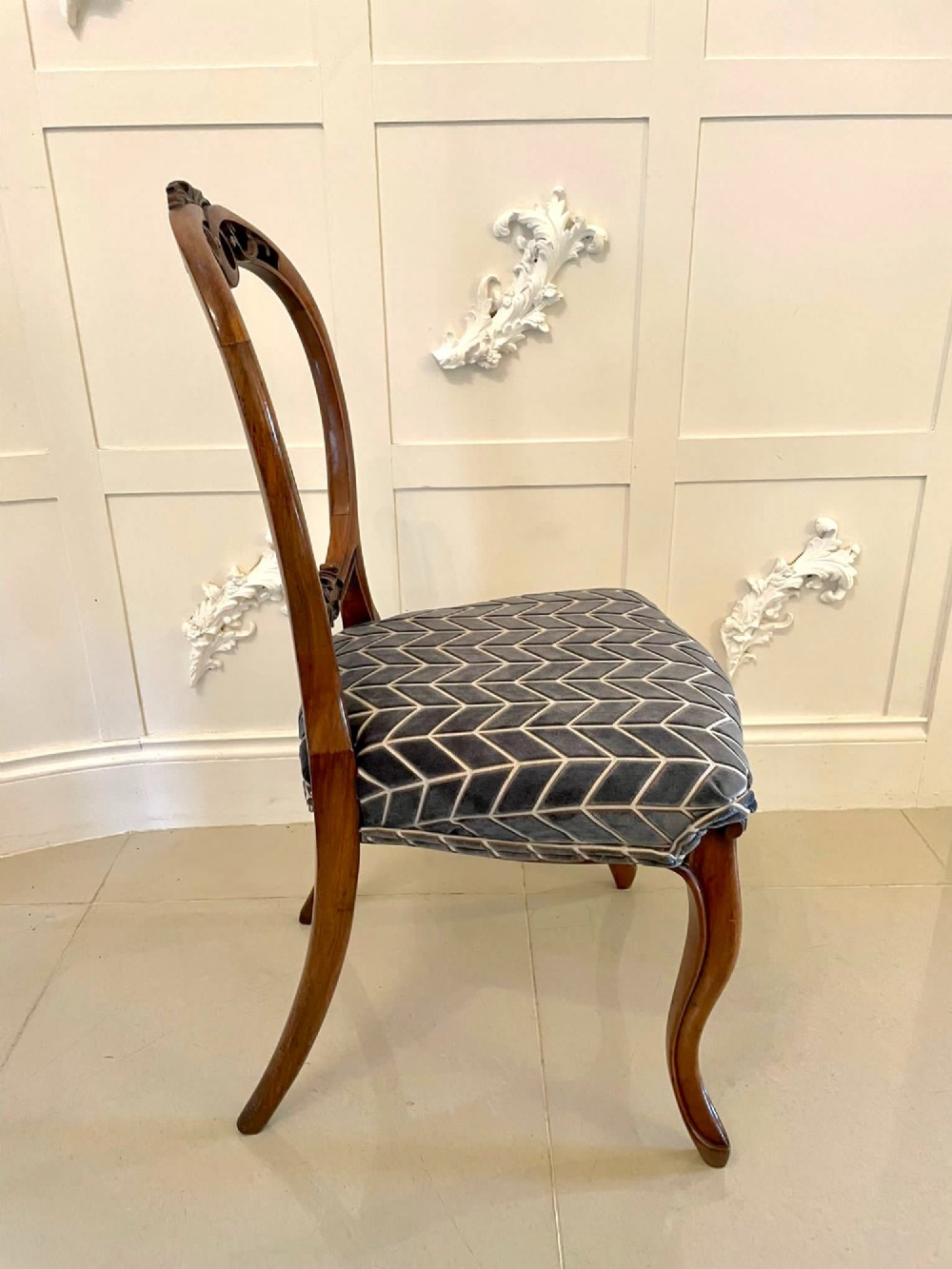 A set of six Victorian carved walnut balloon back dining chairs featuring cabriole legs and grey geometric velvet upholstered seats. View V