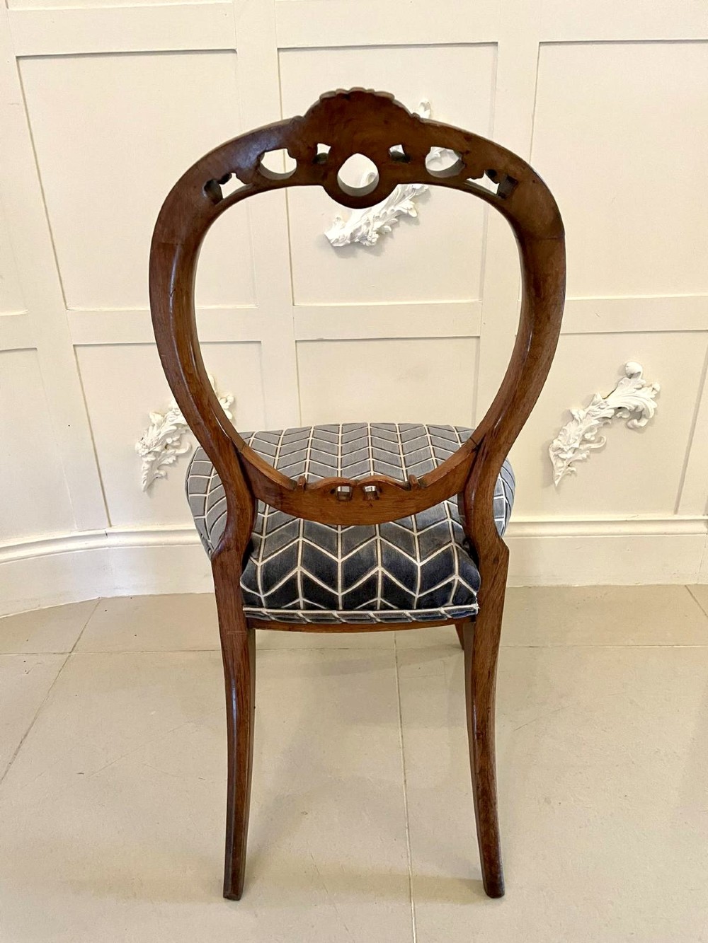 A set of six Victorian carved walnut balloon back dining chairs featuring cabriole legs and grey geometric velvet upholstered seats. View VIII