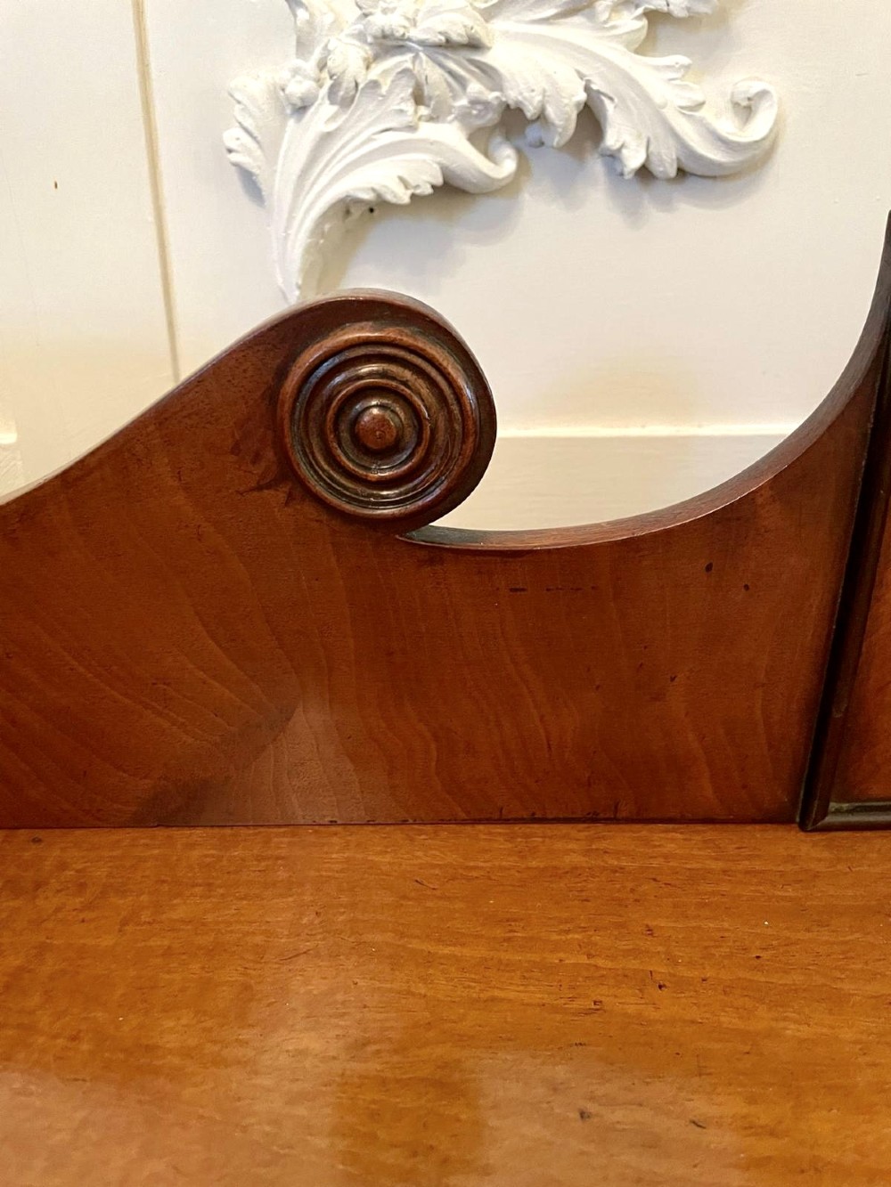 A Regency flame mahogany kneehole desk featuring twin pedestals with multiple drawers, brass ring handles, turned feet, and a shaped back gallery. View V